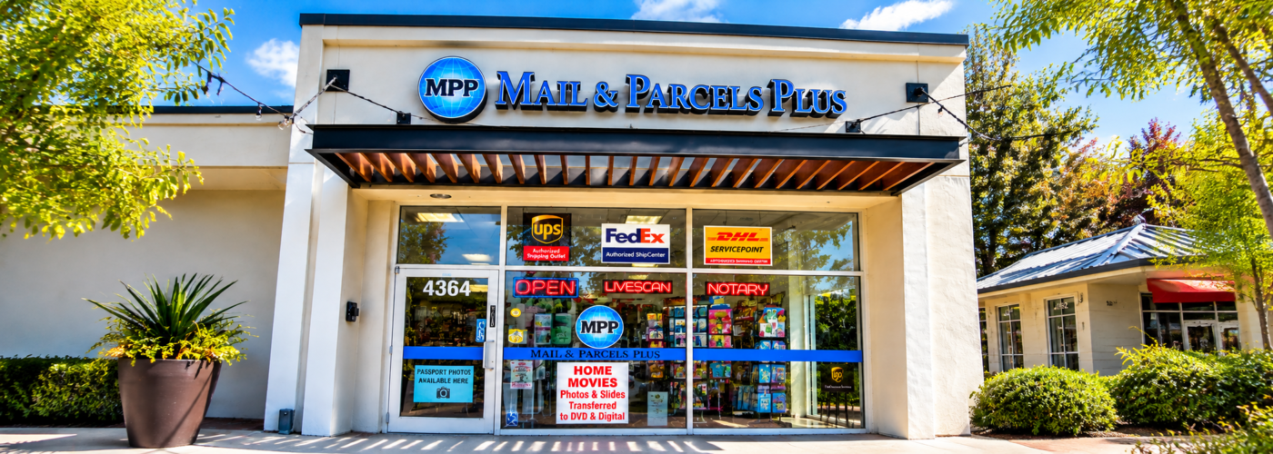 store front banner wider Mail & Parcels Plus shipping, notary and Live Scan service center in Bonita